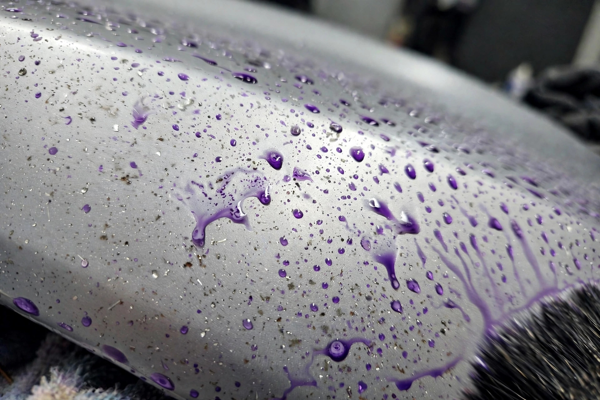 Iron remover pulling embedded iron particles out of car paint, purple spots