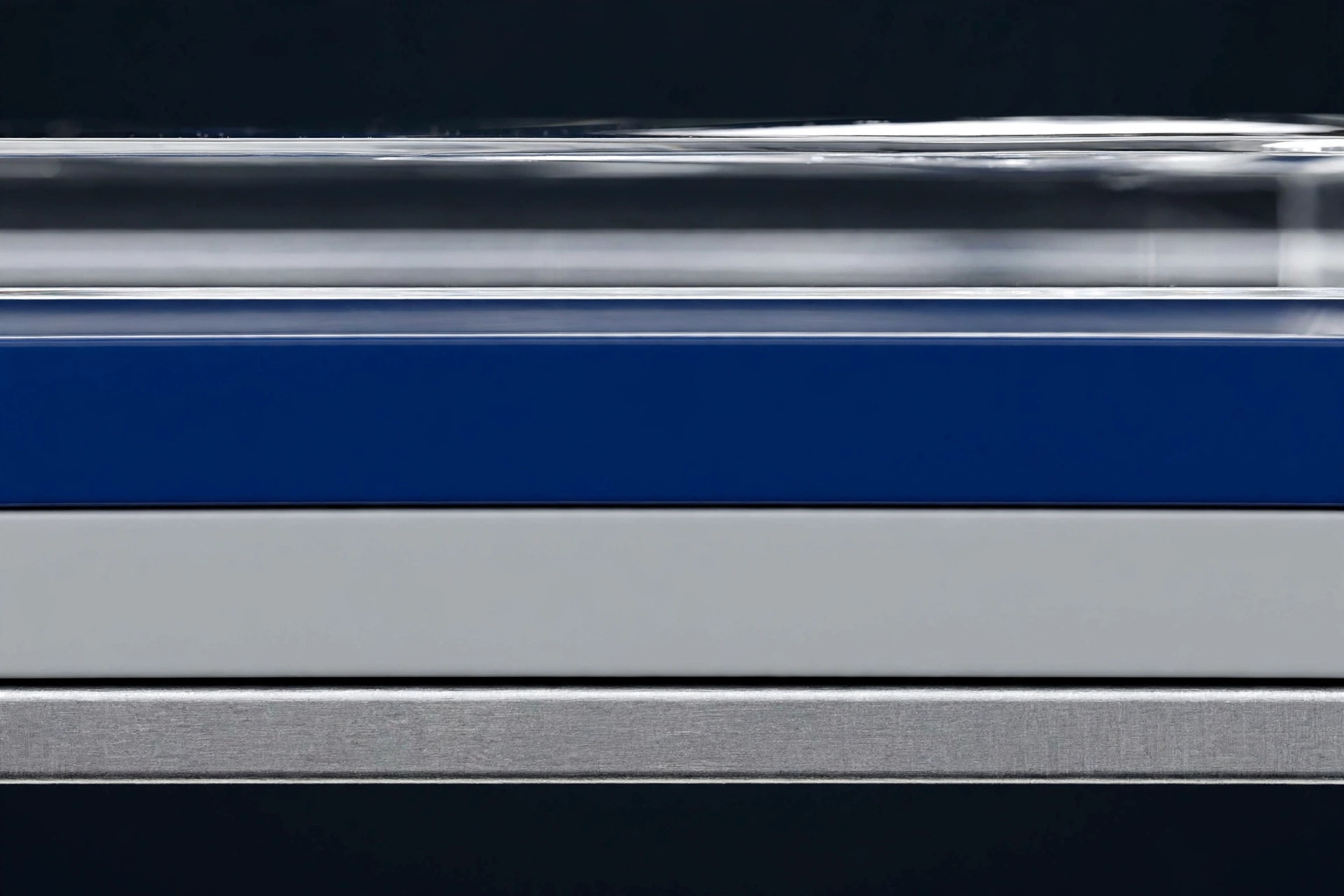 Macro cross-section showing primer, color base coat, and clear coat layers of car paint
